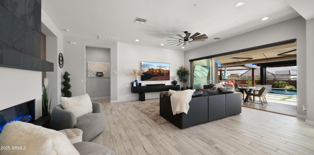 8149 E Jaeger St, Mesa, AZ 85207 - living room with ceiling fan, light wood finished floors, recessed lighting, and baseboards