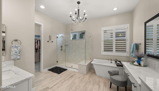 8149 E Jaeger St, Mesa, AZ 85207 - bathroom with a stall shower, vanity, a freestanding tub, a chandelier, and a spacious closet