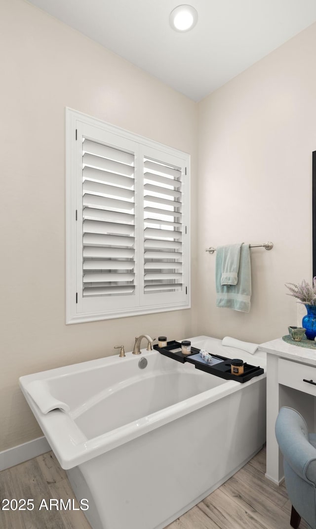 8149 E Jaeger St, Mesa, AZ 85207 - full bath with wood finished floors, a freestanding bath, and baseboards