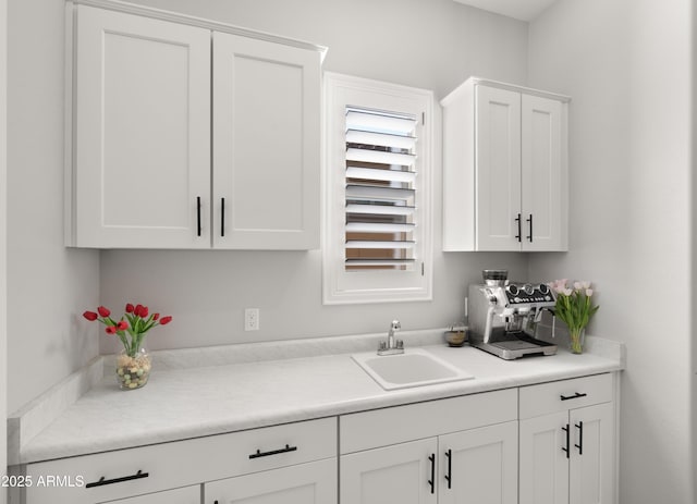 8149 E Jaeger St, Mesa, AZ 85207 - kitchen with a sink, white cabinets, and light countertops