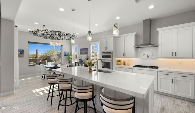 8149 E Jaeger St, Mesa, AZ 85207 - kitchen with wall chimney exhaust hood, gas stovetop, stainless steel double oven, backsplash, and recessed lighting