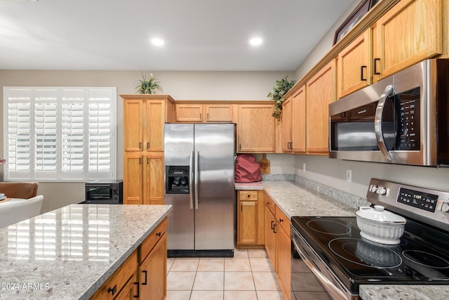 kitchen featuring light tile patterned flooring, a toaster, recessed lighting, appliances with stainless steel finishes, and light stone countertops