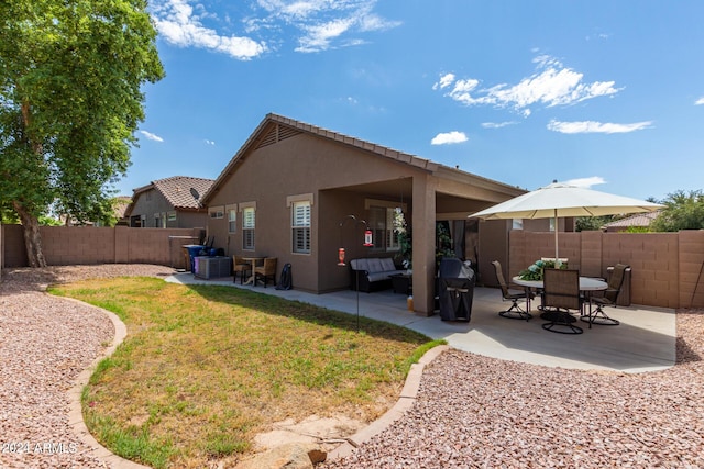 rear view of property featuring a patio, a fenced backyard, central AC, a yard, and stucco siding