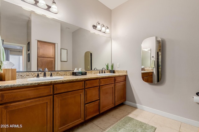 4241 N Pebblecreek Pkwy Unit 7, Goodyear, AZ 85395 - bathroom featuring tile patterned floors, double vanity, and baseboards