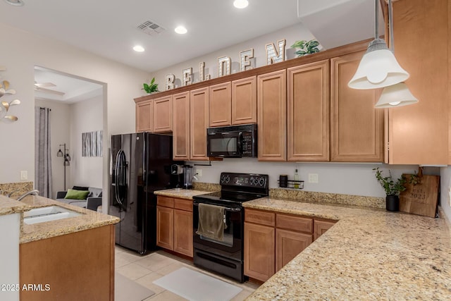 4241 N Pebblecreek Pkwy Unit 7, Goodyear, AZ 85395 - kitchen featuring black appliances, light stone countertops, a sink, pendant lighting, and light tile patterned floors