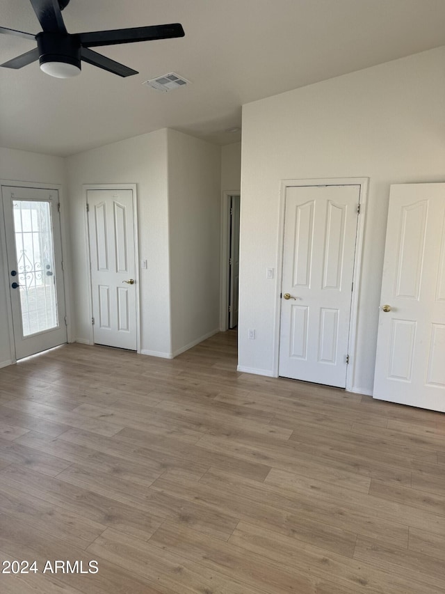 empty room featuring ceiling fan and light wood-type flooring