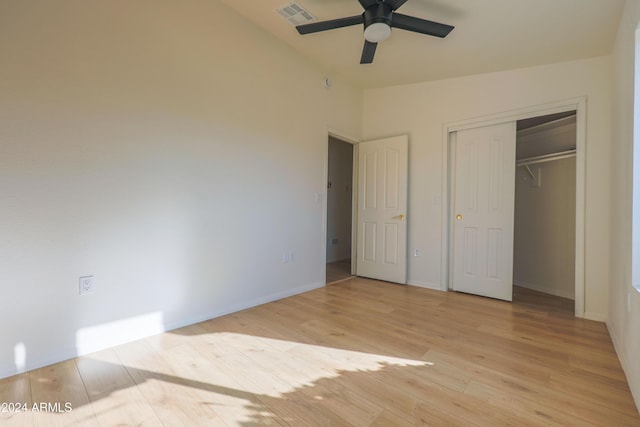 unfurnished bedroom with ceiling fan, light hardwood / wood-style floors, and a closet