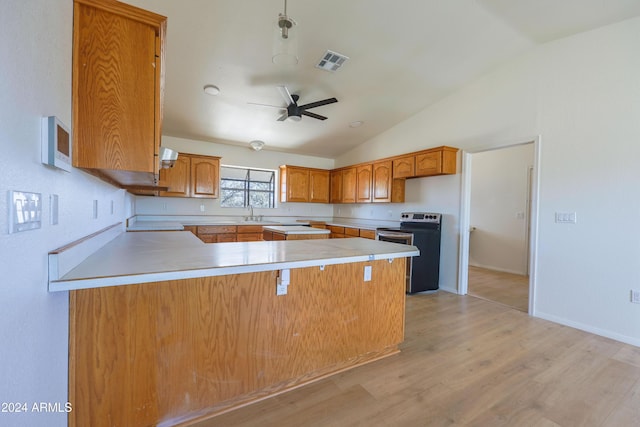 kitchen featuring electric range oven, lofted ceiling, ceiling fan, light hardwood / wood-style floors, and kitchen peninsula