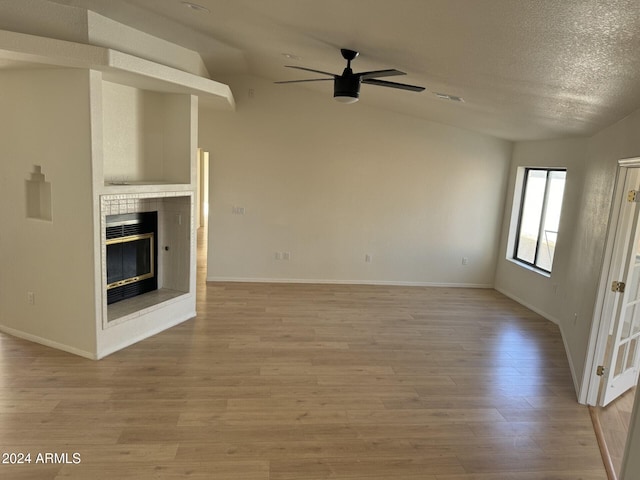 unfurnished living room with lofted ceiling and light hardwood / wood-style flooring