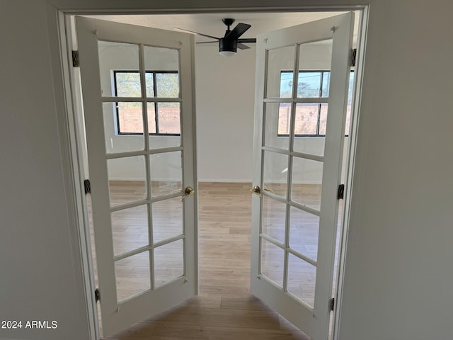 doorway with ceiling fan, french doors, and light hardwood / wood-style floors