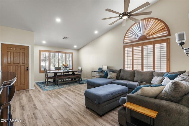 living room with vaulted ceiling, light hardwood / wood-style flooring, and ceiling fan