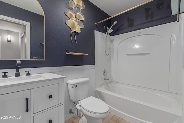 full bathroom with vanity, wood-type flooring, bathtub / shower combination, and toilet