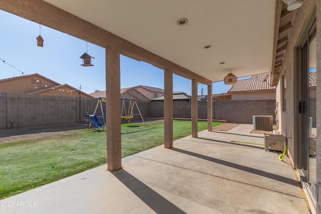 view of patio with a playground and central air condition unit