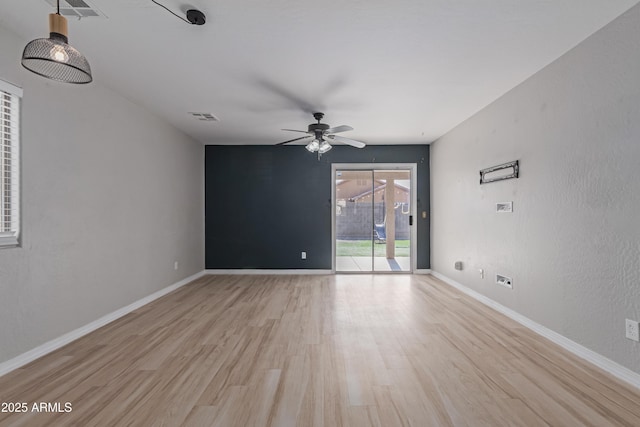 unfurnished room with ceiling fan and light wood-type flooring