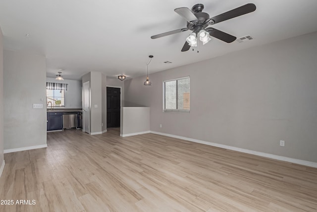 unfurnished living room featuring light wood-type flooring and ceiling fan