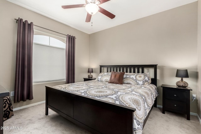 carpeted bedroom featuring baseboards and ceiling fan