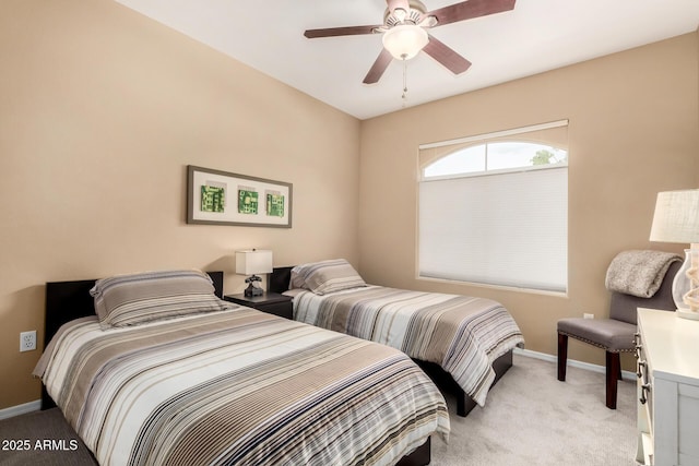 bedroom featuring a ceiling fan, light colored carpet, and baseboards