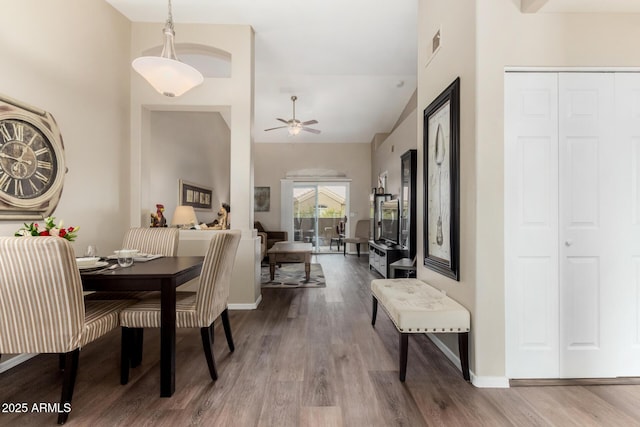 dining space with visible vents, baseboards, ceiling fan, and wood finished floors