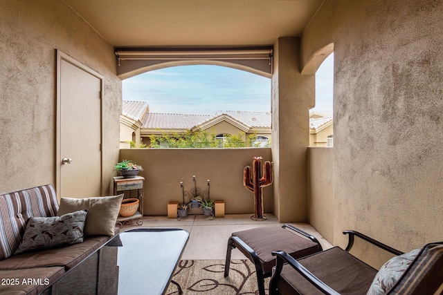 view of patio with an outdoor living space and a balcony