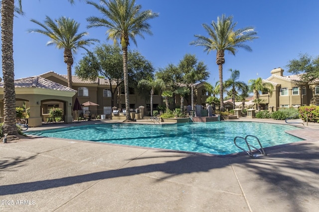 community pool with a patio area