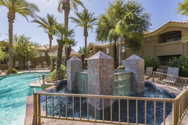 pool featuring a patio area and fence