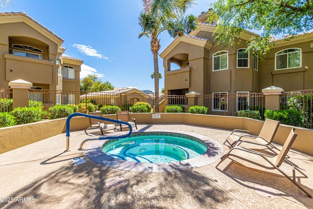 view of pool with a patio, a community hot tub, and fence