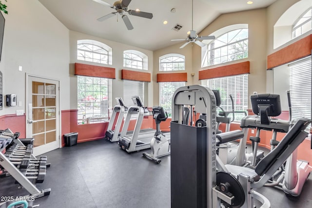 workout area featuring plenty of natural light, a ceiling fan, visible vents, and high vaulted ceiling