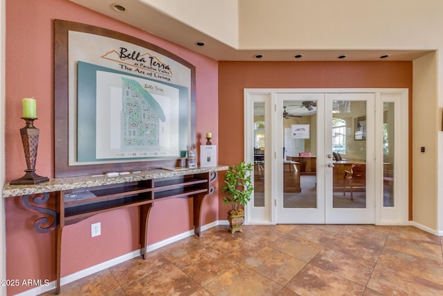 interior space featuring light stone counters, french doors, and baseboards