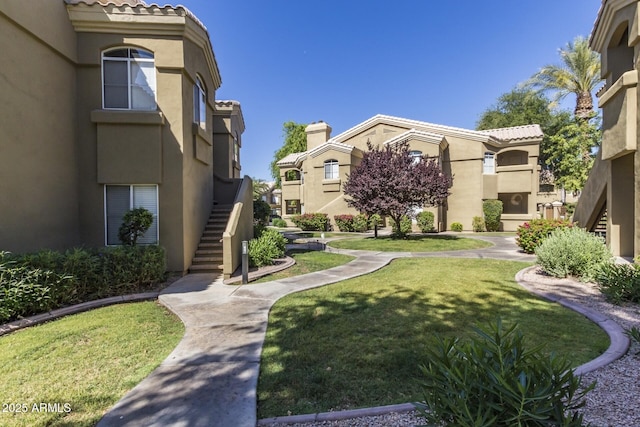 surrounding community featuring stairway and a yard