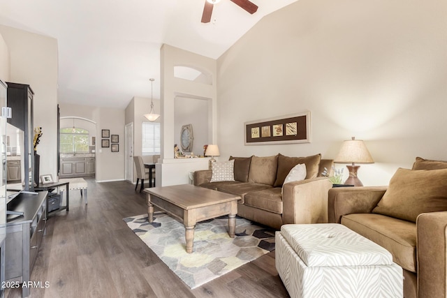 living area with dark wood finished floors, high vaulted ceiling, and ceiling fan