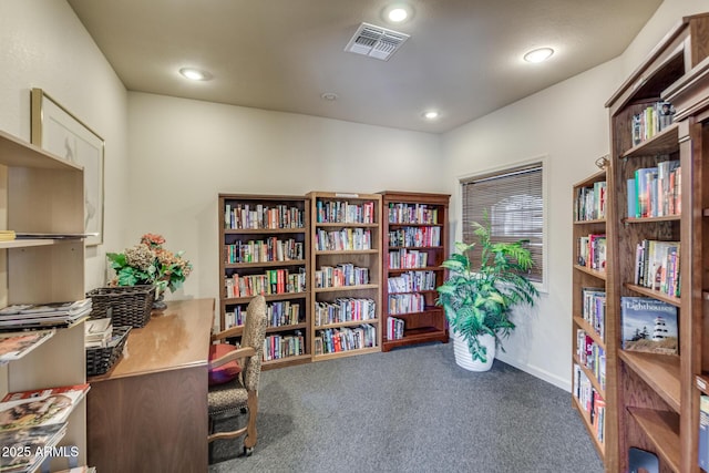 sitting room with visible vents, baseboards, carpet, bookshelves, and recessed lighting