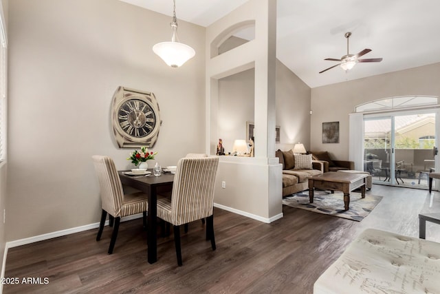 dining space featuring ceiling fan, high vaulted ceiling, baseboards, and wood finished floors