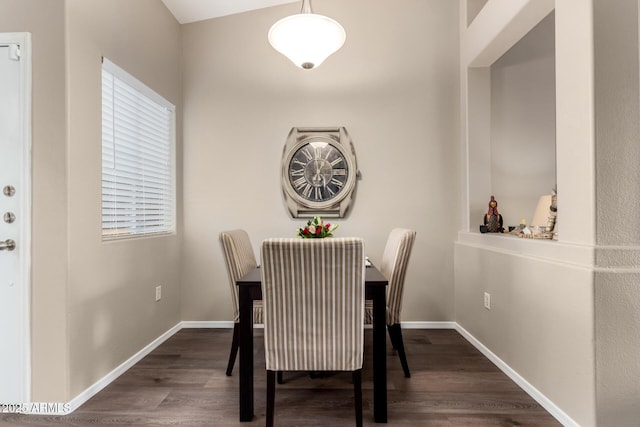 dining space featuring baseboards and dark wood-style flooring