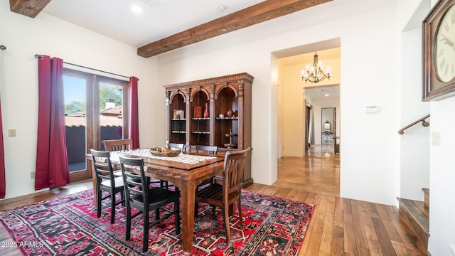 dining room with hardwood / wood-style flooring and an inviting chandelier