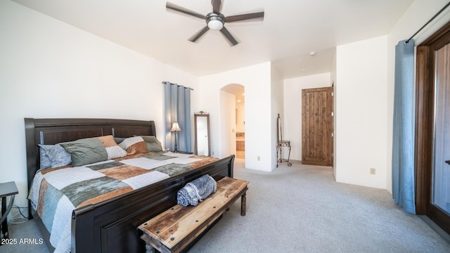 carpeted bedroom featuring ceiling fan and ensuite bathroom