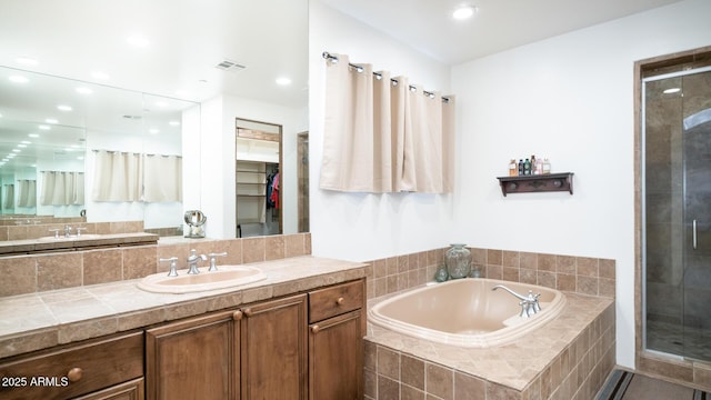 bathroom featuring independent shower and bath and vanity