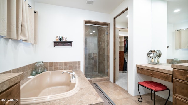 bathroom with shower with separate bathtub and tile patterned floors