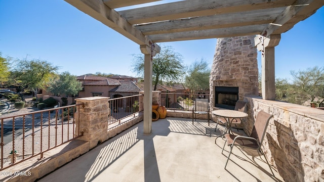 view of patio with an outdoor stone fireplace