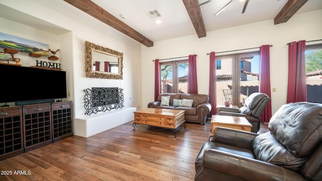 living room featuring hardwood / wood-style floors and beam ceiling