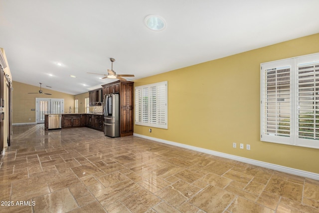 kitchen featuring baseboards, smart refrigerator, a ceiling fan, and a peninsula
