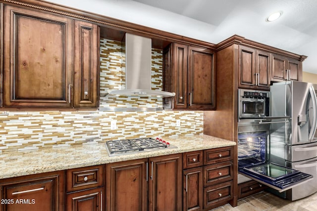kitchen with wall chimney range hood, tasteful backsplash, light stone counters, stainless steel appliances, and recessed lighting