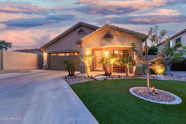 single story home featuring fence, an attached garage, a front lawn, stucco siding, and driveway