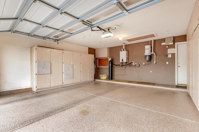garage featuring a garage door opener and tankless water heater
