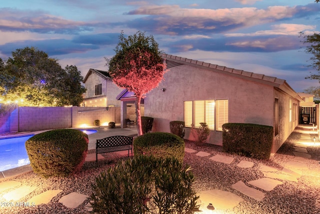exterior space featuring a fenced backyard, a patio area, and stucco siding