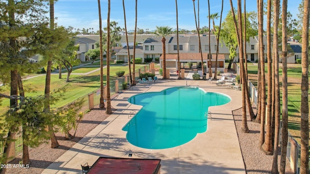 view of swimming pool with a yard and a patio area