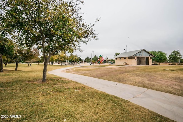 view of community with a playground and a yard