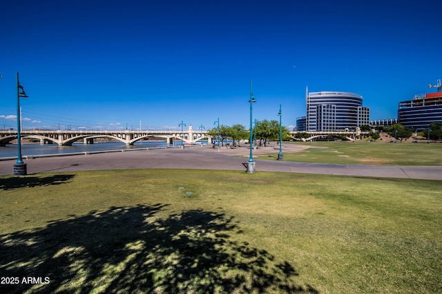 view of community with a water view and a yard