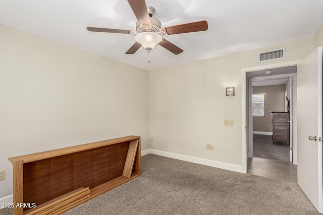 empty room with carpet floors and ceiling fan