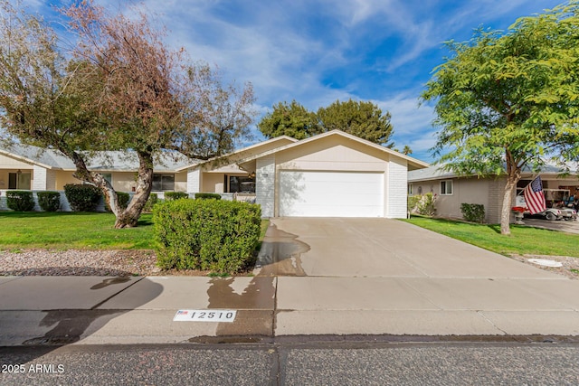 ranch-style house with a garage and a front lawn