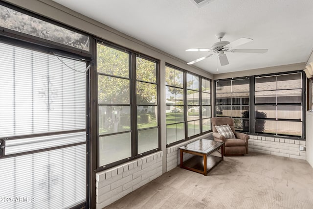 sunroom / solarium featuring ceiling fan